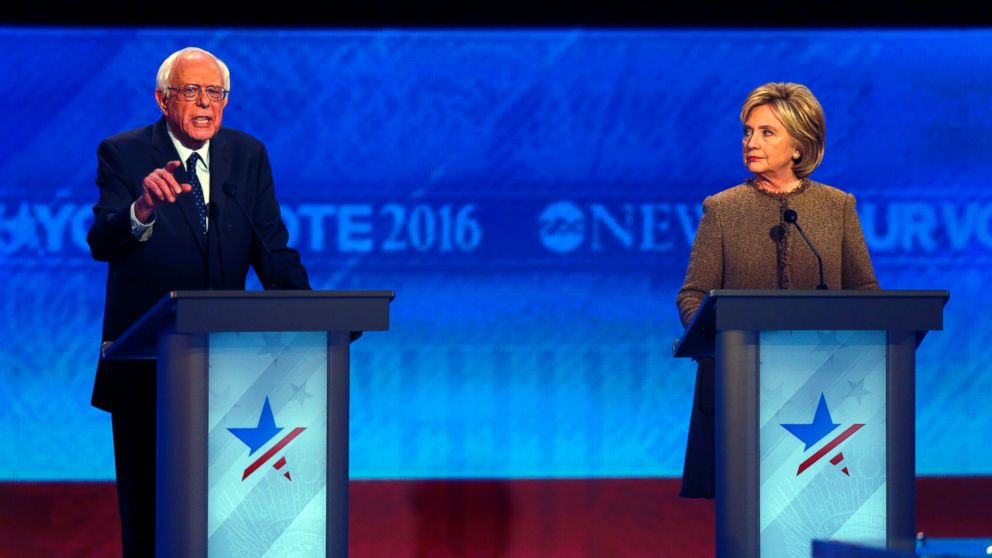 Bernie Sanders, left, speaks while Hillary Clinton listens during a Democratic presidential primary debate, Dec. 19, 2015, at Saint Anselm College in Manchester, N.H.