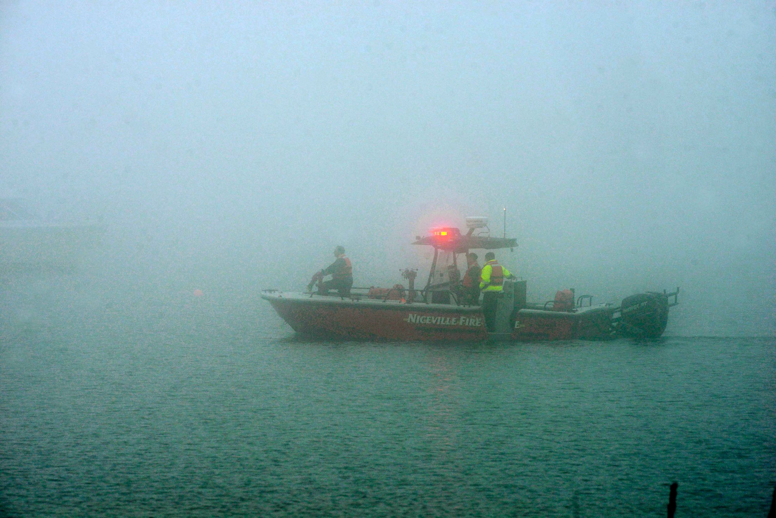 PHOTO: A search boat from the Niceville Fire Department is shrouded in fog as rescue workers search a site near Navarre Beach, Fla., March 11, 2015, where an Army Black Hawk helicopter crashed.
