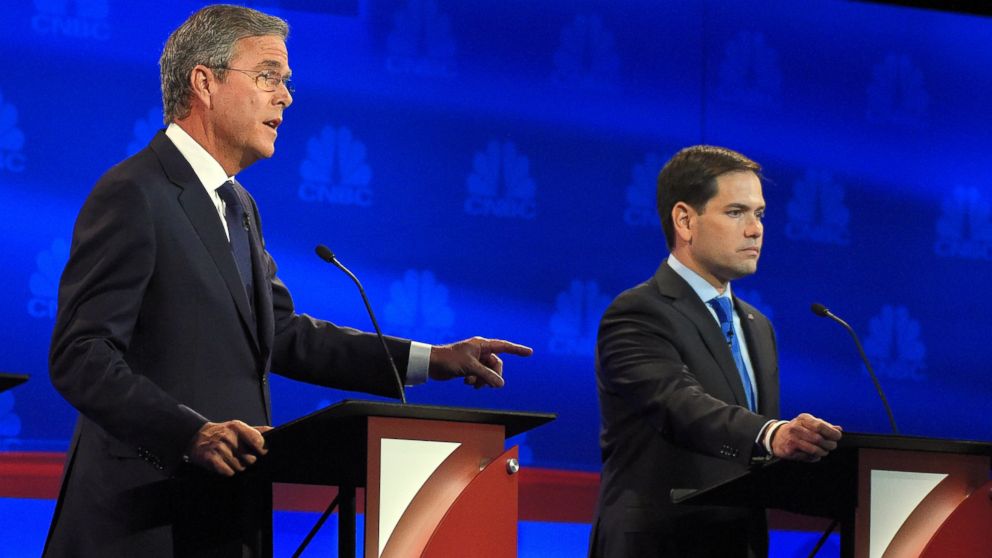 Jeb Bush, left, speaks as Marco Rubio looks on during the CNBC Republican presidential debate at the University of Colorado, Oct. 28, 2015, in Boulder, Colo. 