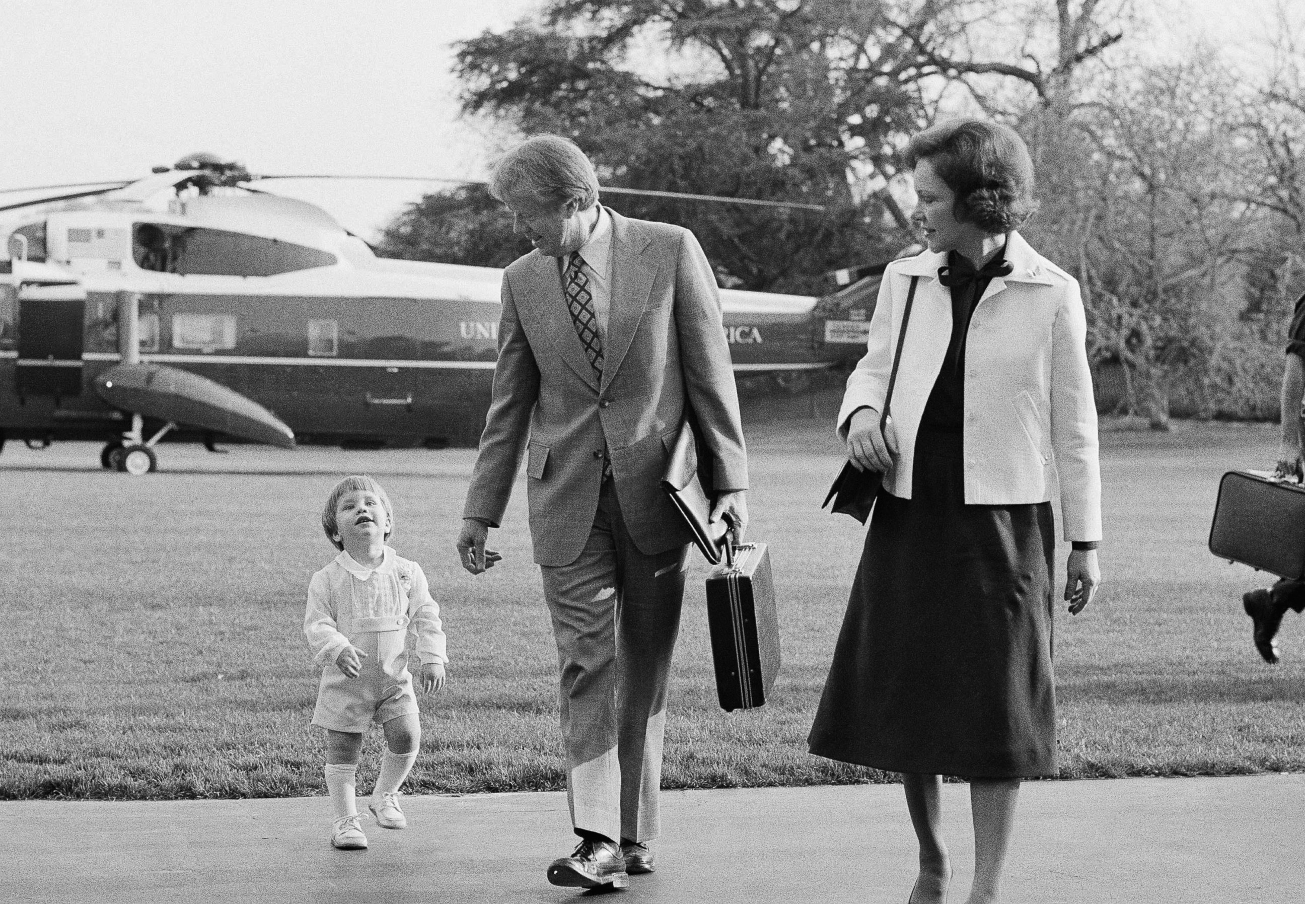 PHOTO: President Jimmy Carter, center, Rosalynn Carter, right, and grandson Jason Carter, left, return to the White House on April 11, 1977 in Washington, D.C.