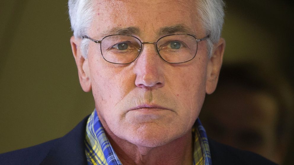 U.S. Defense Secretary Chuck Hagel is seen aboard a U.S. Military Aircraft before speaking to members of the media during his flight, Sunday, June 1, 2014. 