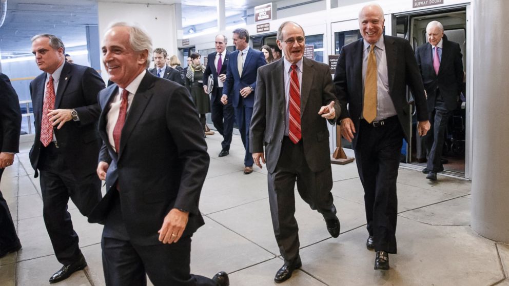 Senators rush to the floor for a procedural vote to advance the $585 billion defense bill at the Capitol in Washington, Dec. 11, 2014.
