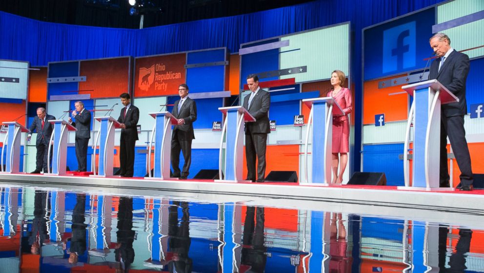 Republican presidential candidates from left, Jim Gilmore, Lindsey Graham, Bobby Jindal, Rick Perry, Rick Santorum, Carly Fiorina, and George Pataki participate in a pre-debate forum at the Quicken Loans Arena, Aug. 6, 2015, in Cleveland. 
