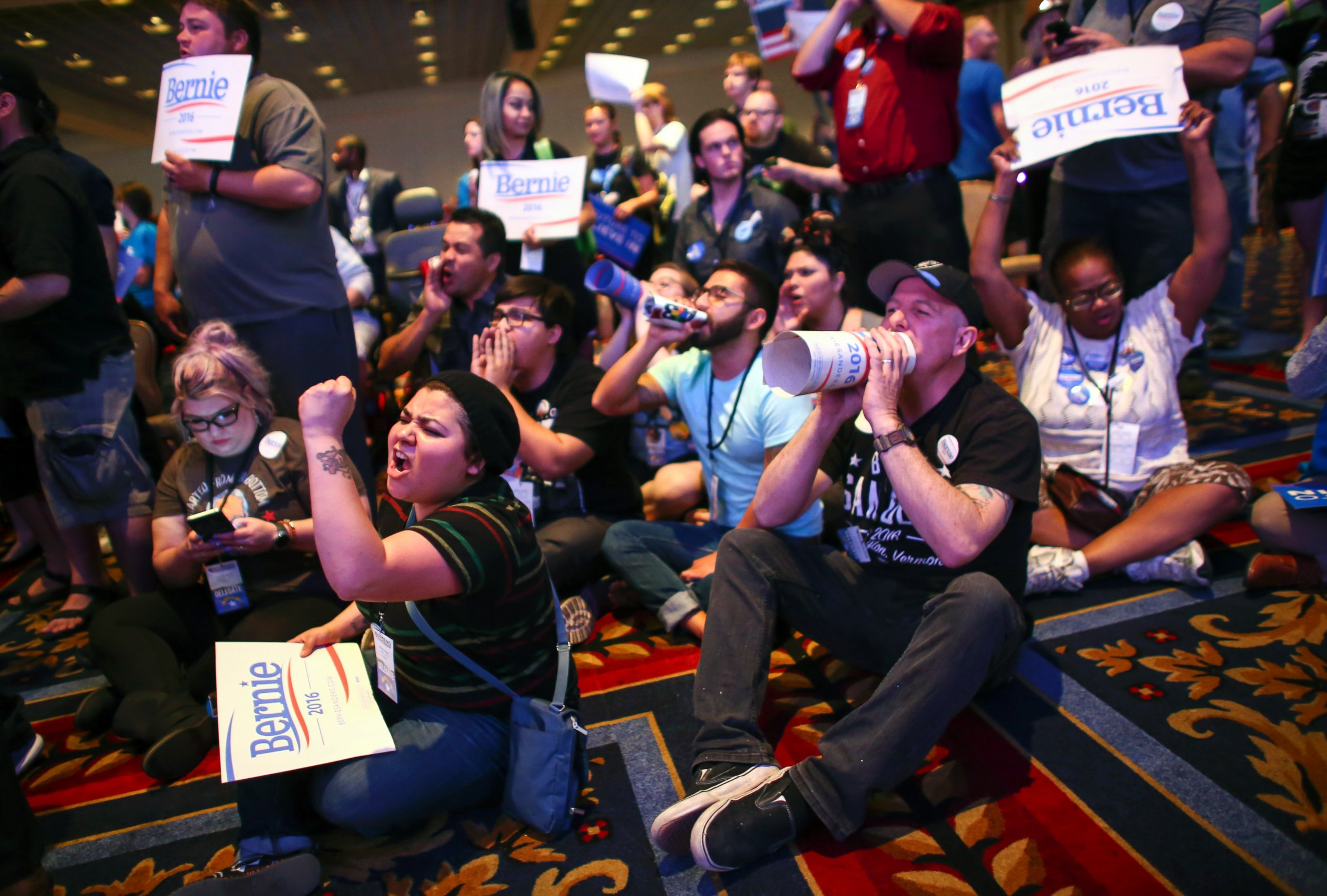 PHOTO: Supporters of Democratic presidential candidate Bernie Sanders, including Valeria Romano, center left, and Johnny Hancen, center right, gather in the front of the room during the Nevada State Democratic Party, May 14, 2016.