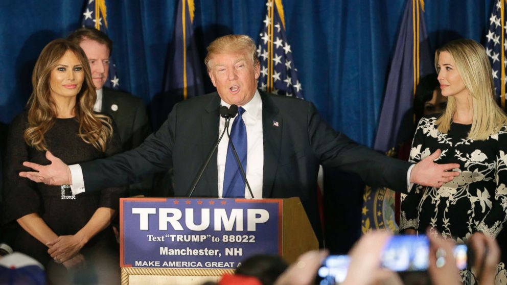 Republican presidential candidate Donald Trump speaks to supporters during a primary night rally, Feb. 9, 2016, in Manchester, N.H. At his side are his wife Melania Trump, left, and daughter Ivanka Trump, right. 