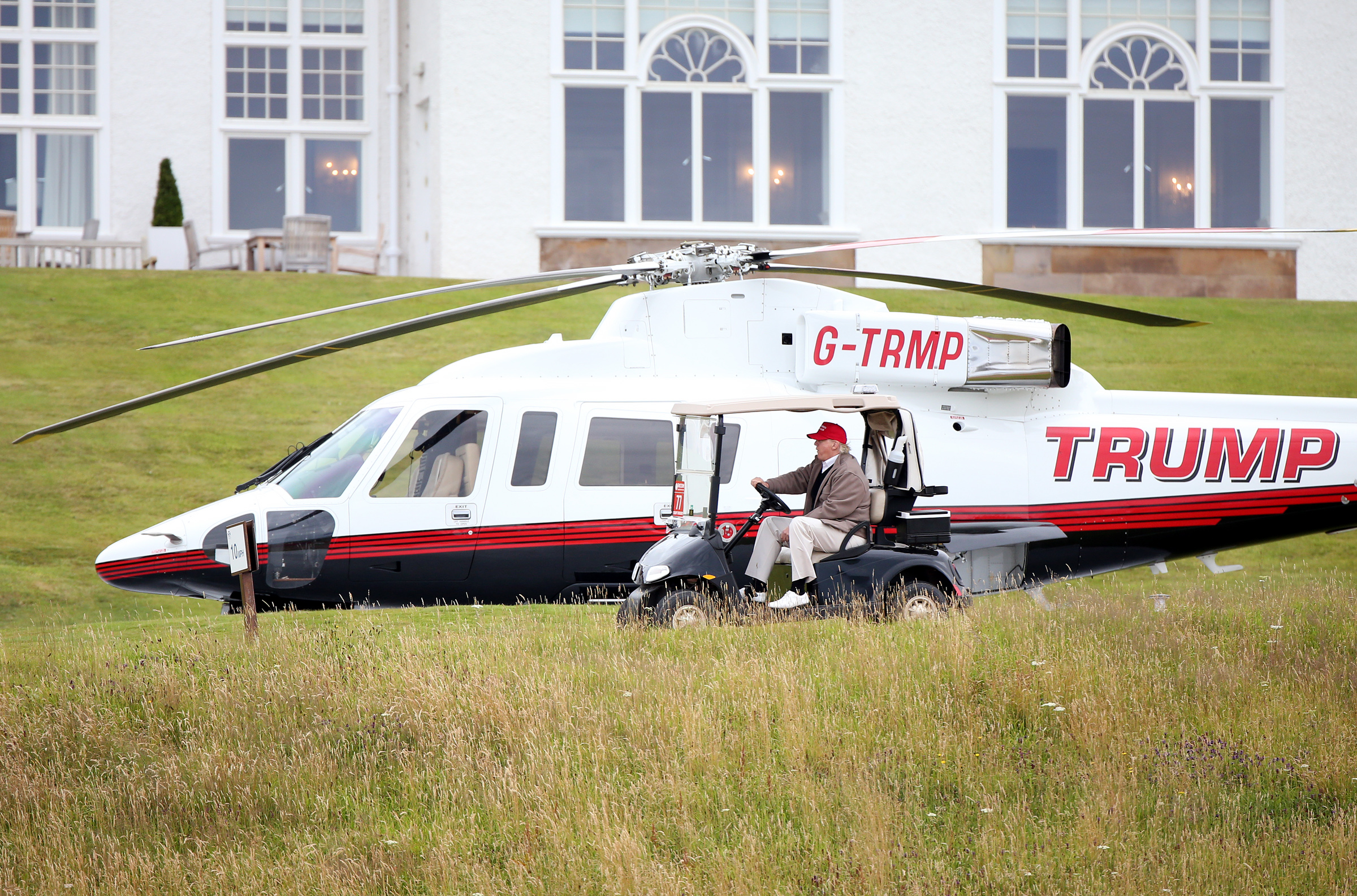 PHOTO: Presidential contender Donald Trump drives his golf buggy past his helicopter during the second day of the Women's British Open golf championship on the Turnberry golf course in Turnberry, Scotland,  July 31, 2015. 