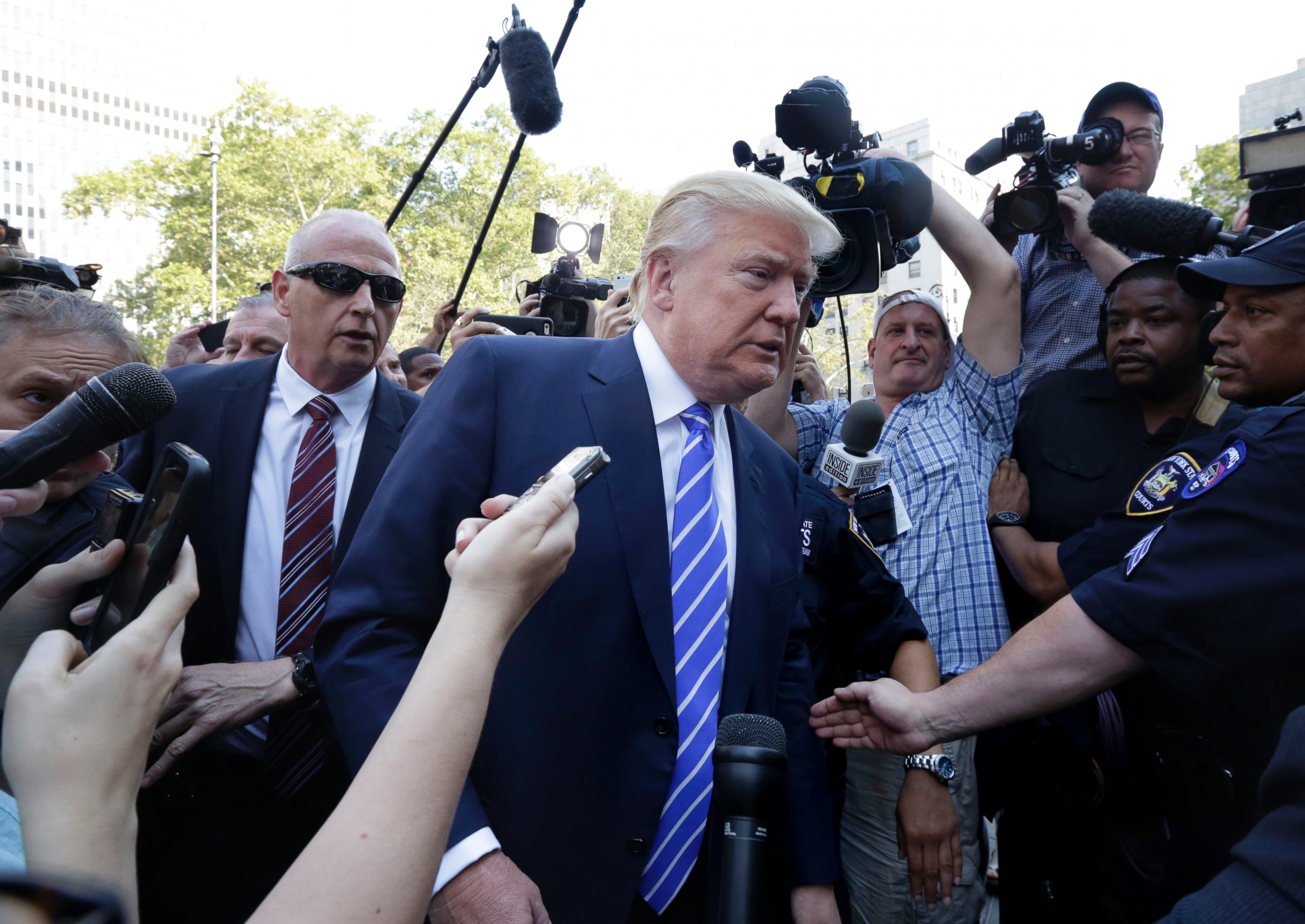 PHOTO: Republican presidential candidate Donald Trump is surrounded by media as he arrives for jury duty in New York, Aug. 17, 2015. 