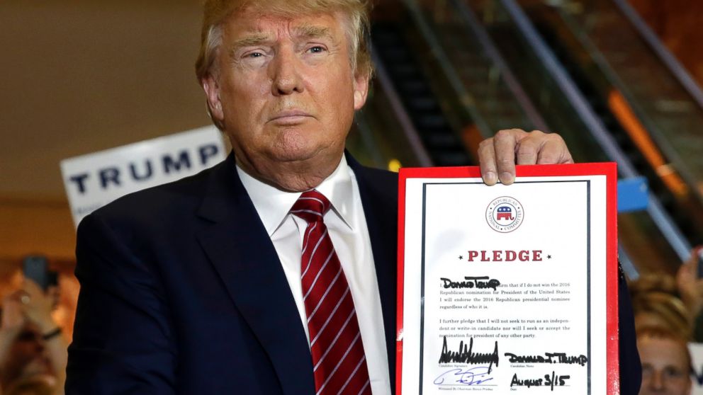 Republican presidential candidate Donald Trump holds his pledge during a news conference, at Trump Tower in New York, Sept. 3, 2015. 
