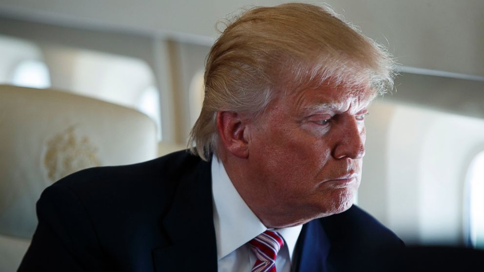 Republican presidential candidate Donald Trump looks out the window, Sept. 5, 2016, aboard his campaign plane flying over Ohio, while talking to the press.