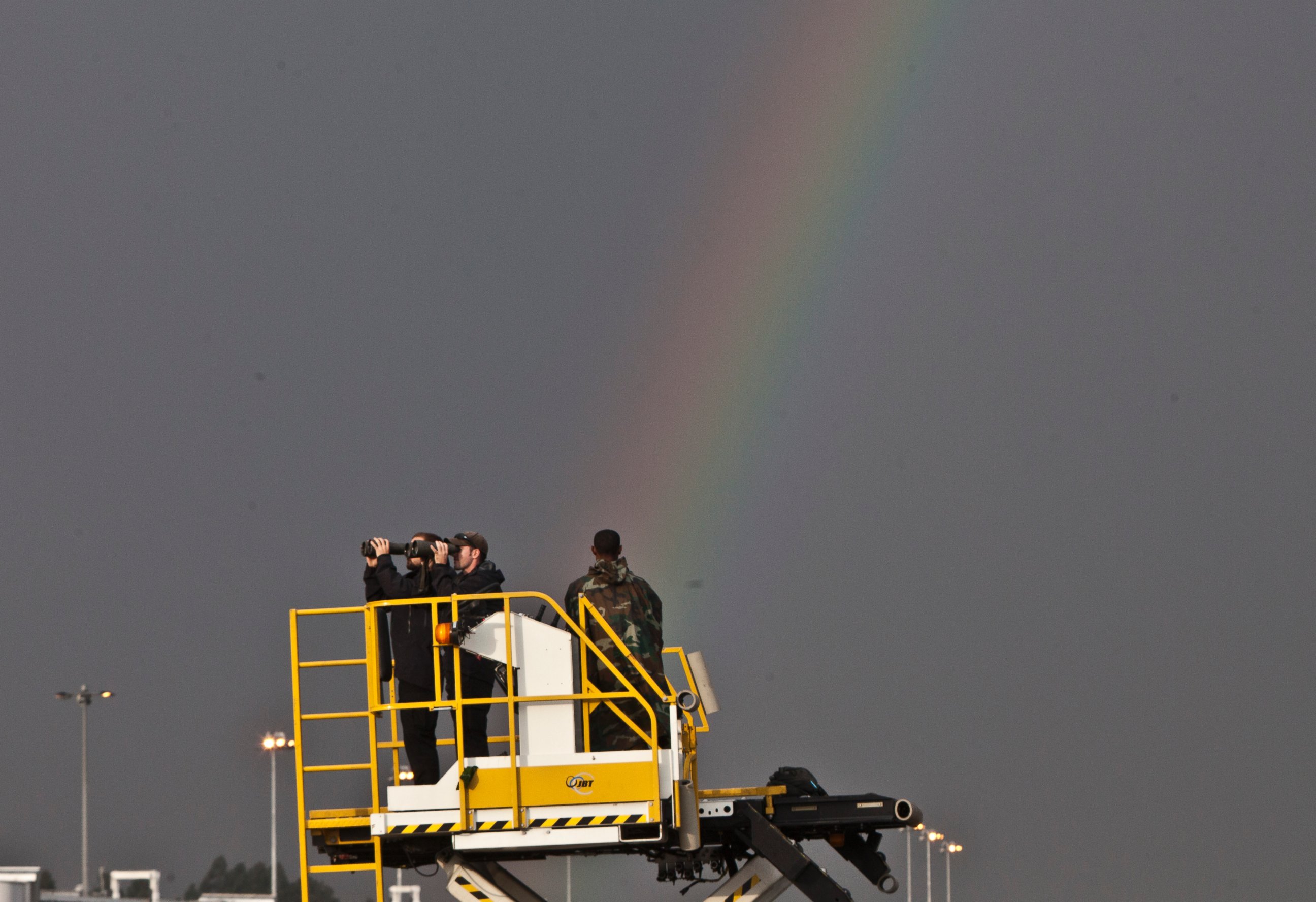PHOTO: Secret Service Agents watch through their binoculars as a rainbow appears in the sky before President Barack Obama arrived at Bole International Airport, July 26, 2015, Addis Ababa, Ethiopia.