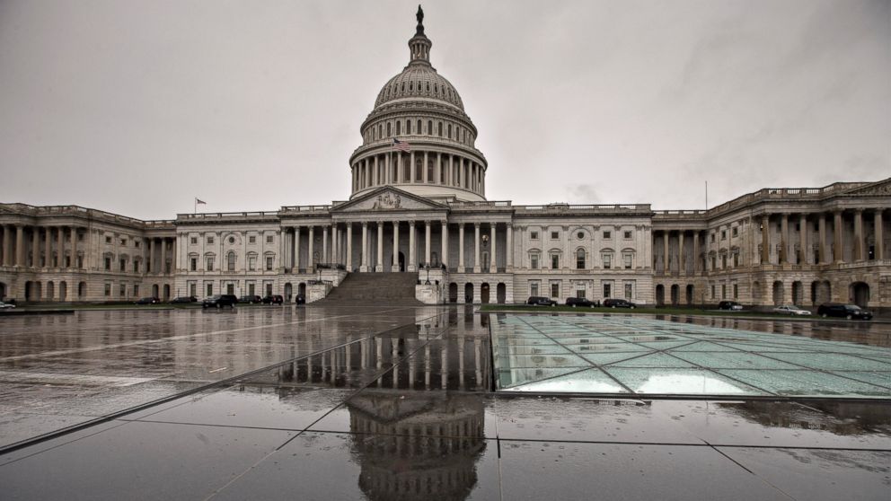 The U.S. Capitol is reflected during rain in Washington, Oct. 7, 2013.