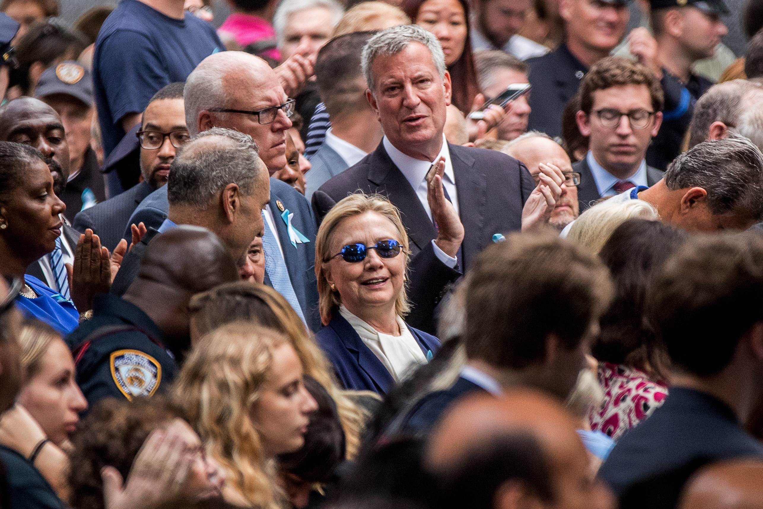 PHOTO: Democratic presidential nominee Hillary Clinton, center, accompanied by Sen. Chuck Schumer, center left, and New York Mayor Bill de Blasio, center top, attends a ceremony at the Sept. 11 memorial, in New York, Sept. 11, 2016. 