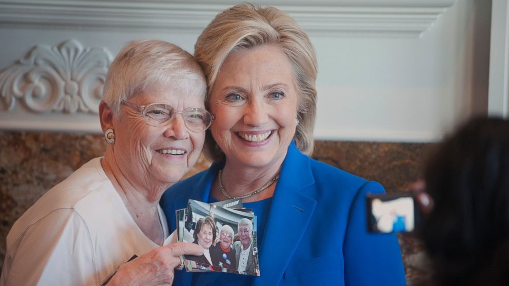 Anita Wendt, of Sioux City, Iowa poses for a photo with Democratic presidential hopeful, former Secretary of State Hillary Rodham Clinton, during a campaign house party, June 13, 2015, in Sioux City, Iowa.