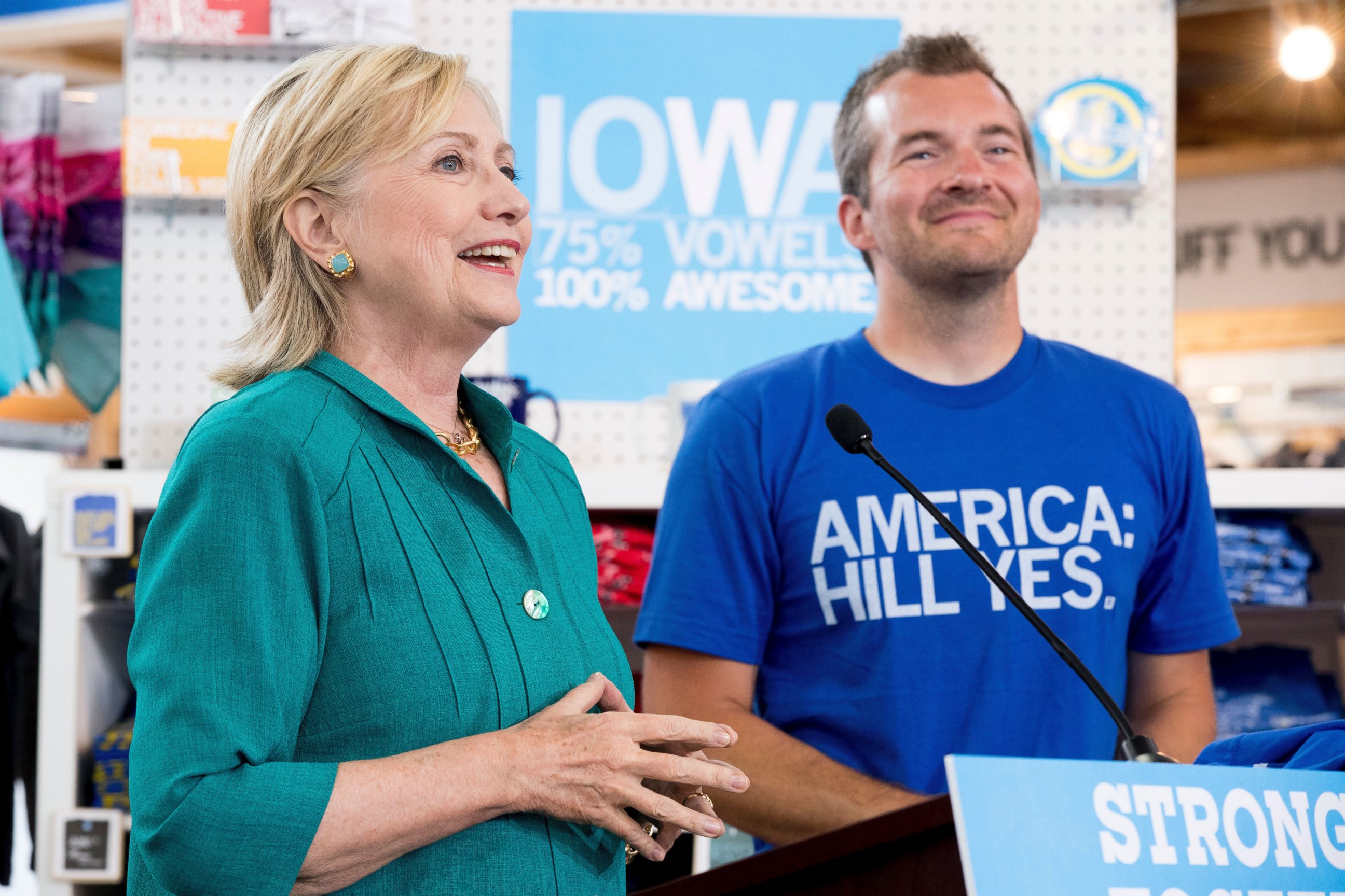 PHOTO: Hillary Clinton, accompanied by owner and founder Mike Draper, right, speaks after she tours Raygun, a printing, design and clothing company, in Des Moines, Iowa, Aug. 10, 2016. 