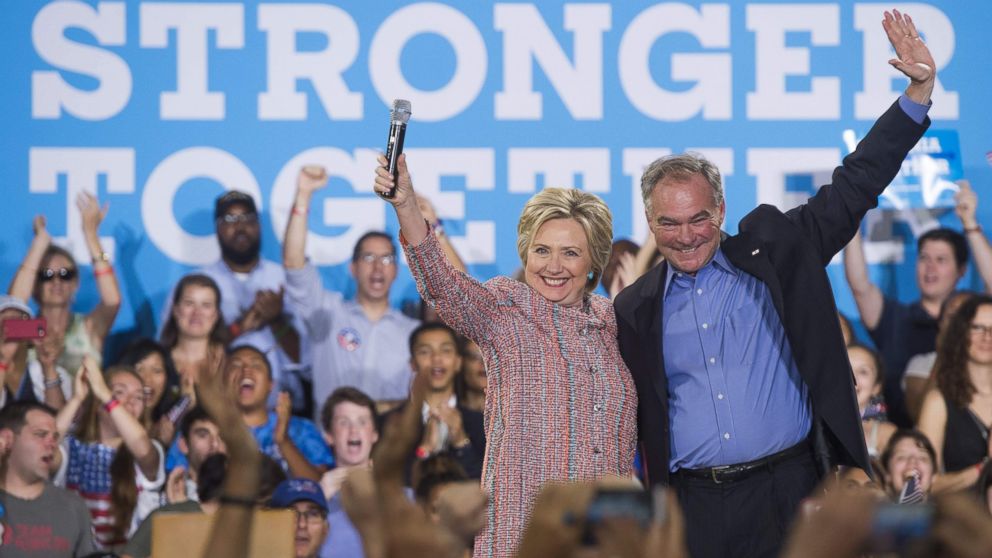 Democratic Presidential candidate Hillary Clinton and Sen. Tim Kaine, Democrat of Virginia, wave during a campaign rally at Ernst Community Cultural Center in Annandale, Virginia, July 14, 2016.