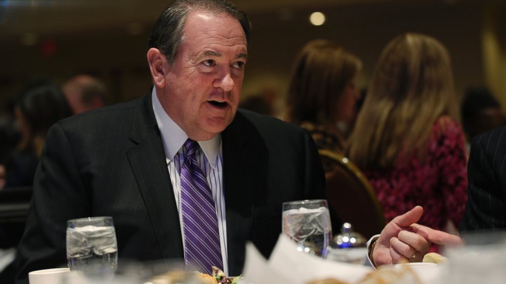 Former Arkansas Gov. Mike Huckabee sits down for lunch before speaking at the Republican National Committee winter meeting in Washington, Jan. 23, 2014.