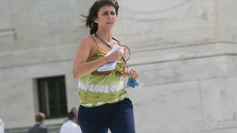 Members of the news media, including interns for network television stations, run with decisions in hand on the opinion for health care in Washington, June 25, 2015, in an official tradition referred to as the "running of the interns.