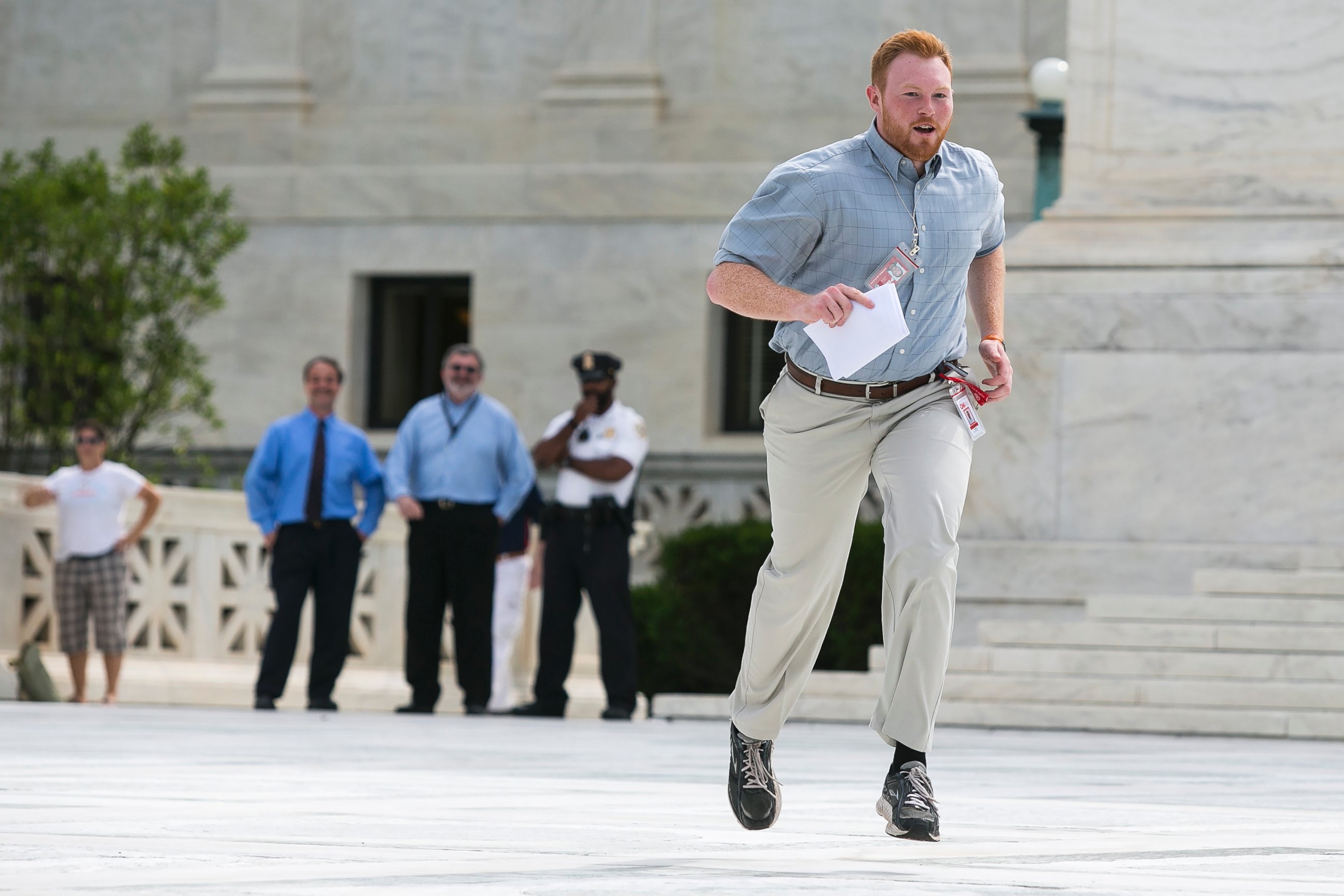 PHOTO: Members of the news media, including interns for network television stations, run with decisions in hand on the opinion for health care in Washington, June 25, 2015, in an official tradition referred to as the "running of the interns." 