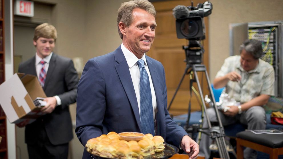 Sen. Jeff Flake, R-Ariz. carries a plate of pork sandwiches into the Senate press gallery on Capitol Hill in Washington, June 11, 2015.