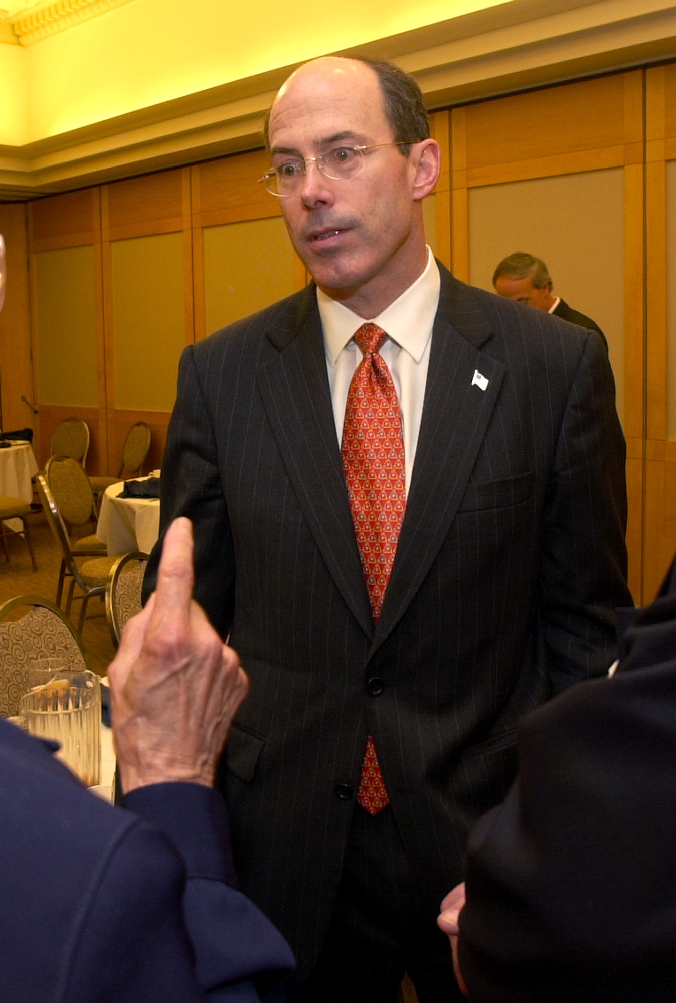 PHOTO: Joseph E. Schmitz, Inspector General of the U.S. Department of Defense, listens to criticism after speaking at the Cleveland City Club, in Cleveland, June 25, 2004. 