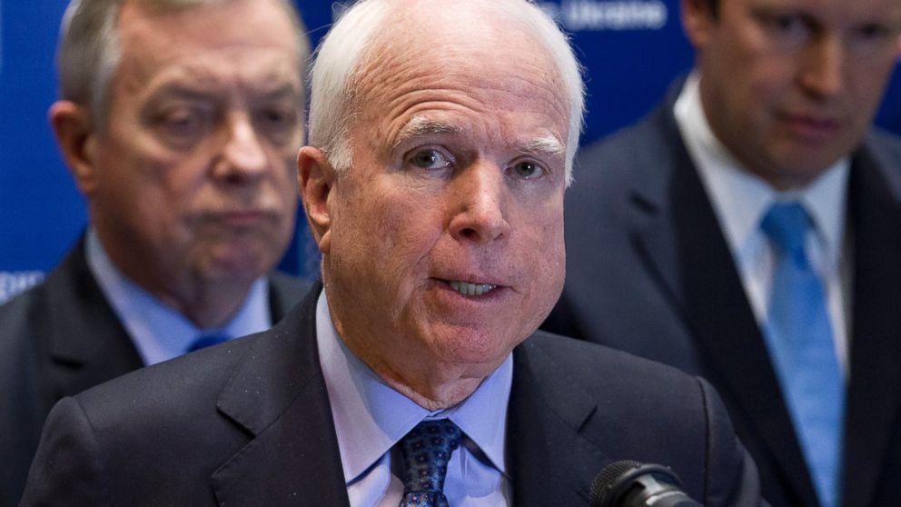 Sen. John McCain, R-Ariz., center, speaks during a news conference in Kiev, Ukraine, March 15, 2014. 