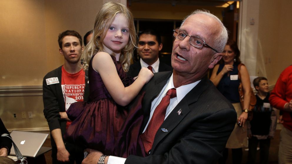 Republican Kerry Bentivolio holds his granddaughter Emily Lee, while greeting supporters at his election night party in Novi, Mich., Nov. 7, 2012. 