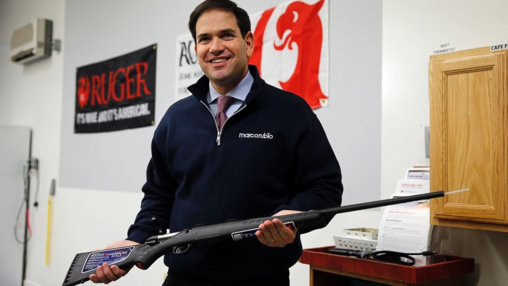 Republican presidential candidate, Sen. Marco Rubio, R-Fla. holds a rifle after being asked to pose for photographs during a campaign stop, Jan. 15, 2016, at Sturm, Ruger & Co., in Newport, N.H. 