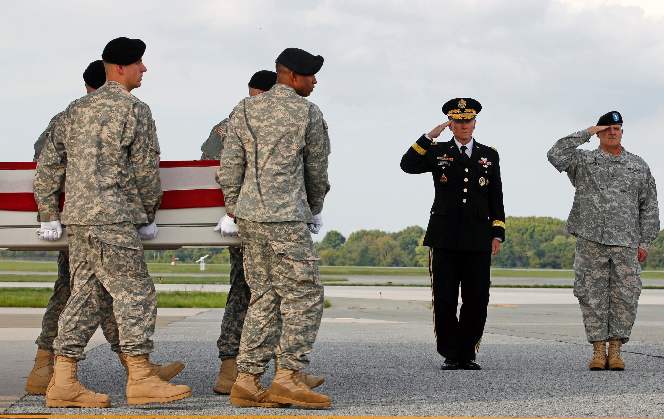 PHOTO: Chairman of the Joint Chiefs of Staff, General Martin E. Dempsey, left, and Army Brig. Gen. Frank D. Turner III salute at Dover Air Force Base, Del., Aug. 10, 2012.