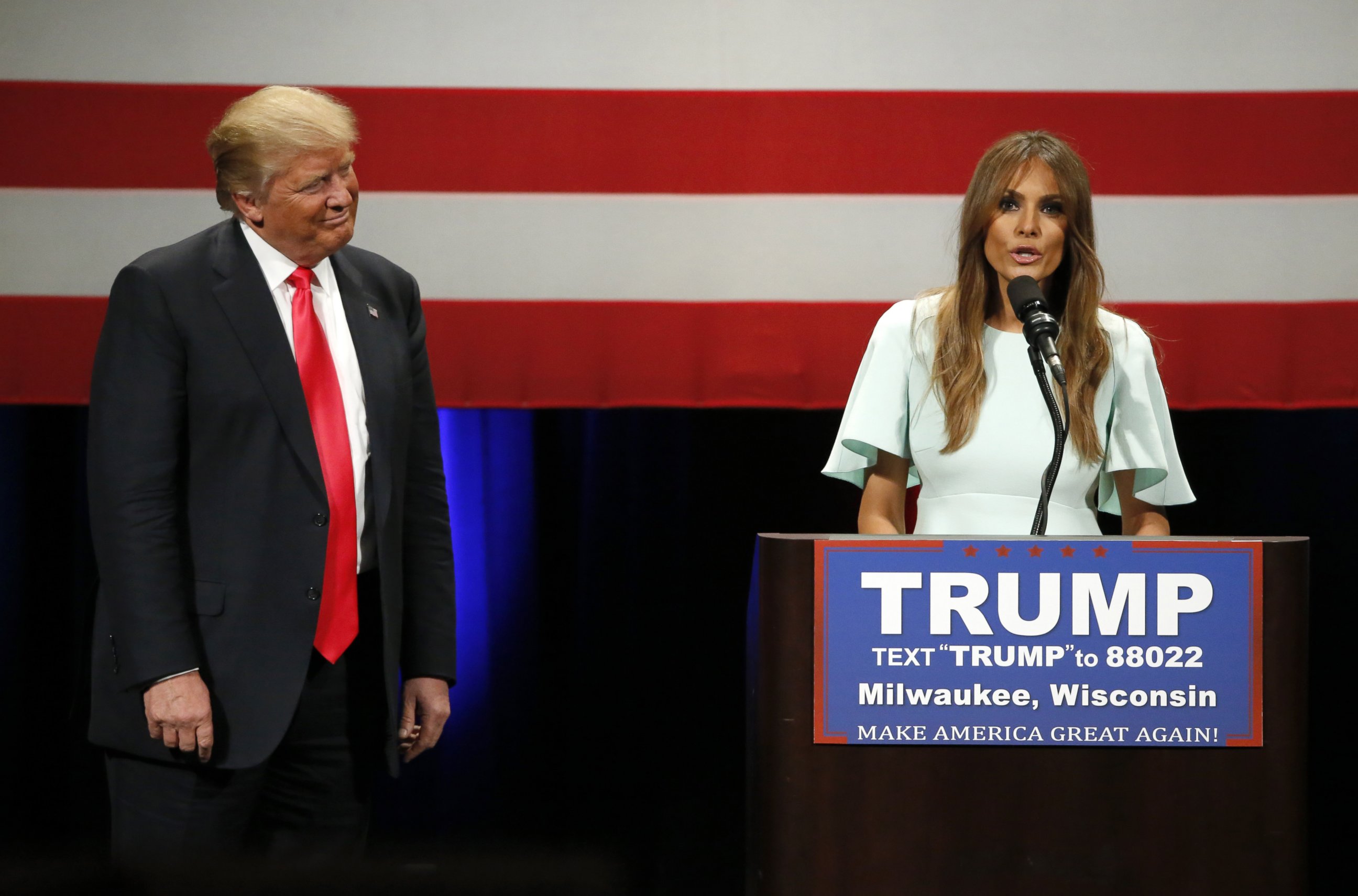 PHOTO:Donald Trump listens to his wife Melania as she addresses the crowd during a rally at the Milwaukee Theatre, April 4, 2016, in Milwaukee.  