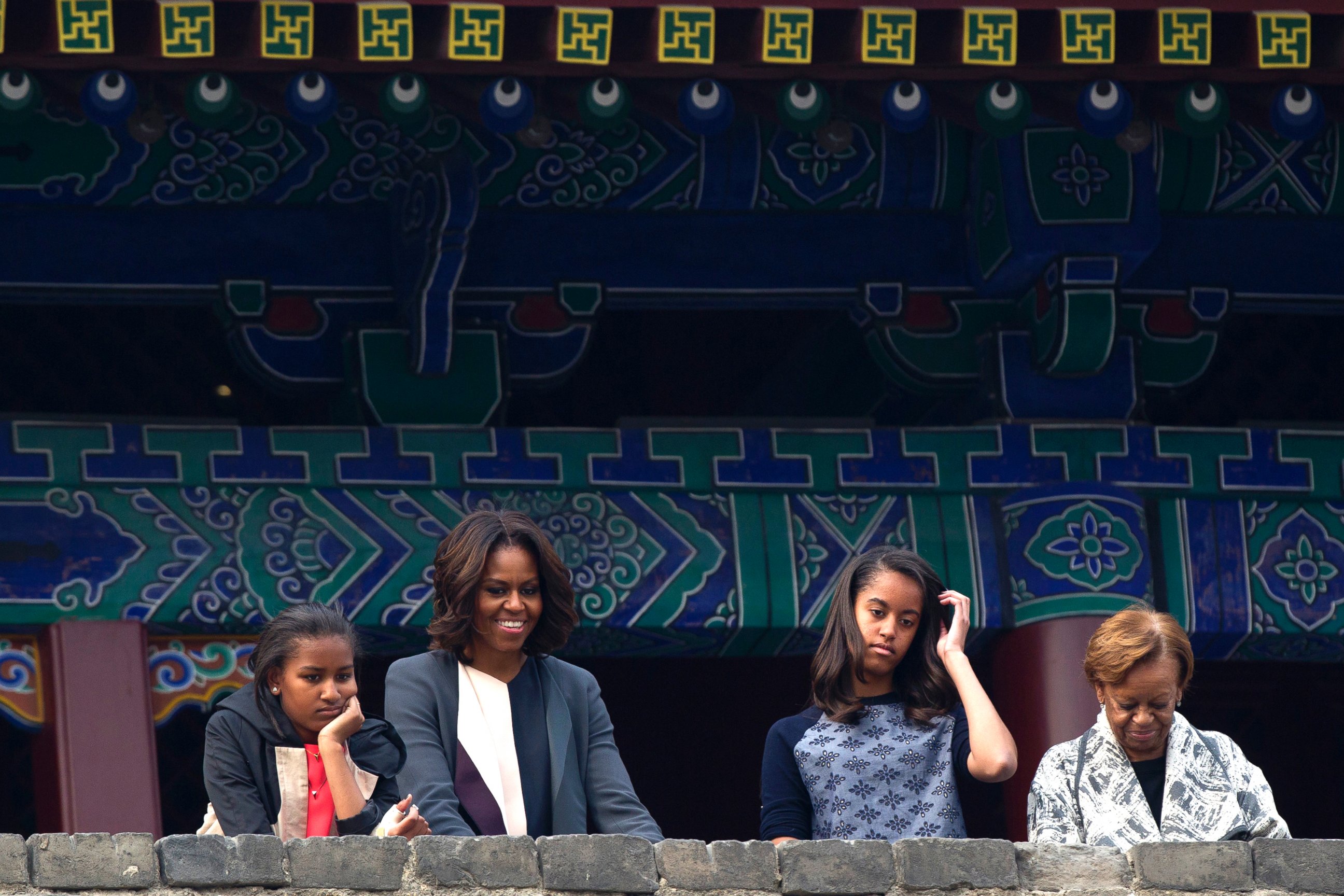 PHOTO: U.S. first lady Michelle Obama, her daughters and mother watch a performance on the top of an ancient city wall in Xi'an, in northwestern China's Shaanxi province, March 24, 2014.