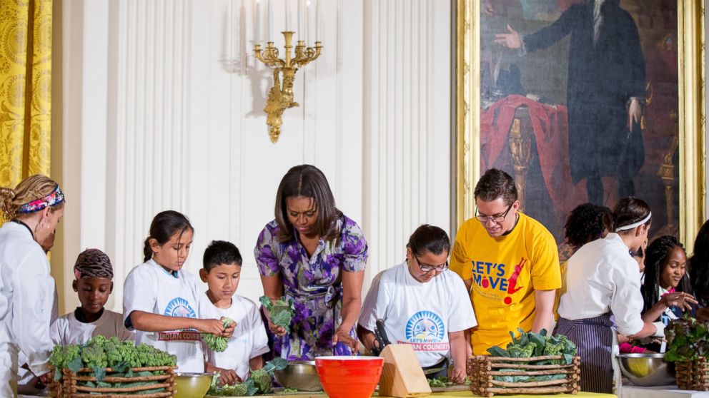 First lady Michelle Obama helps prepare food harvested from the White House Kitchen Garden with children from all over the country who participated in events with the "Let'??s Move!" campaign, June 3, 2015, at the White House.