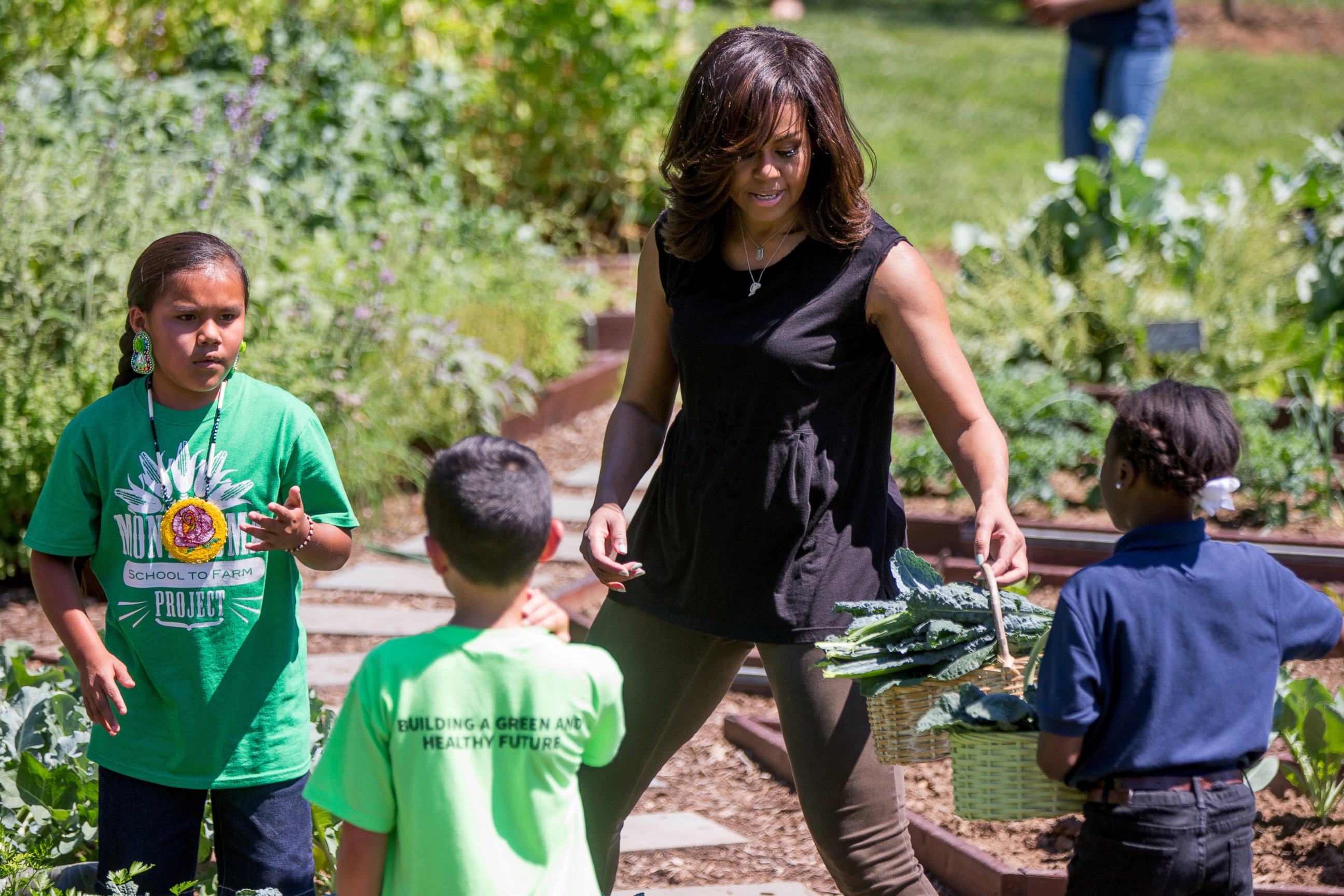 PHOTO: First lady Michelle Obama, joined by school children from across the country, harvest the White House Kitchen Garden, June 6, 2016, at the White House in Washington.