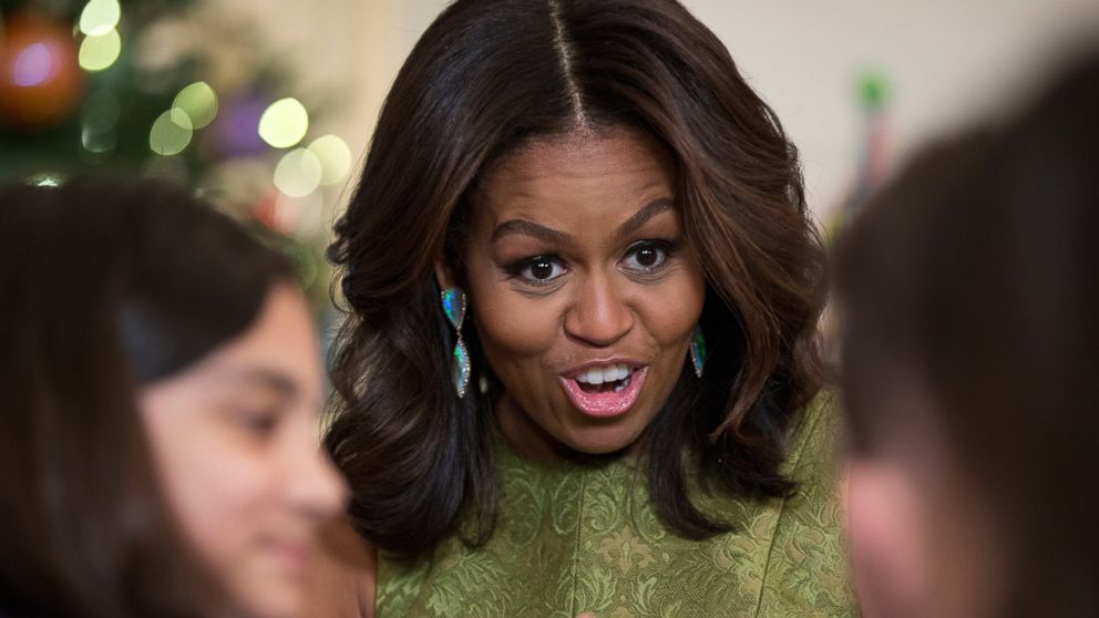 First lady Michelle Obama talks with children in the State Dining Room of the White House in Washington, Wednesday, Dec. 2, 2015.