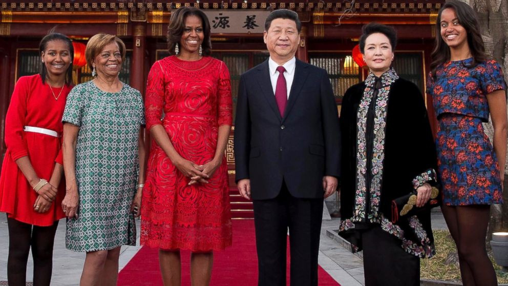 U.S. first lady Michelle Obama, center left, her daughters Malia, right, Sasha, left, Michelle Obama's mother Marian Robinson, second left, pose for photos with Chinese President Xi Jinping, center right, and his wife Peng Liyuan, second right, at the Diaoyutai state guesthouse in Beijing, March 21, 2014.