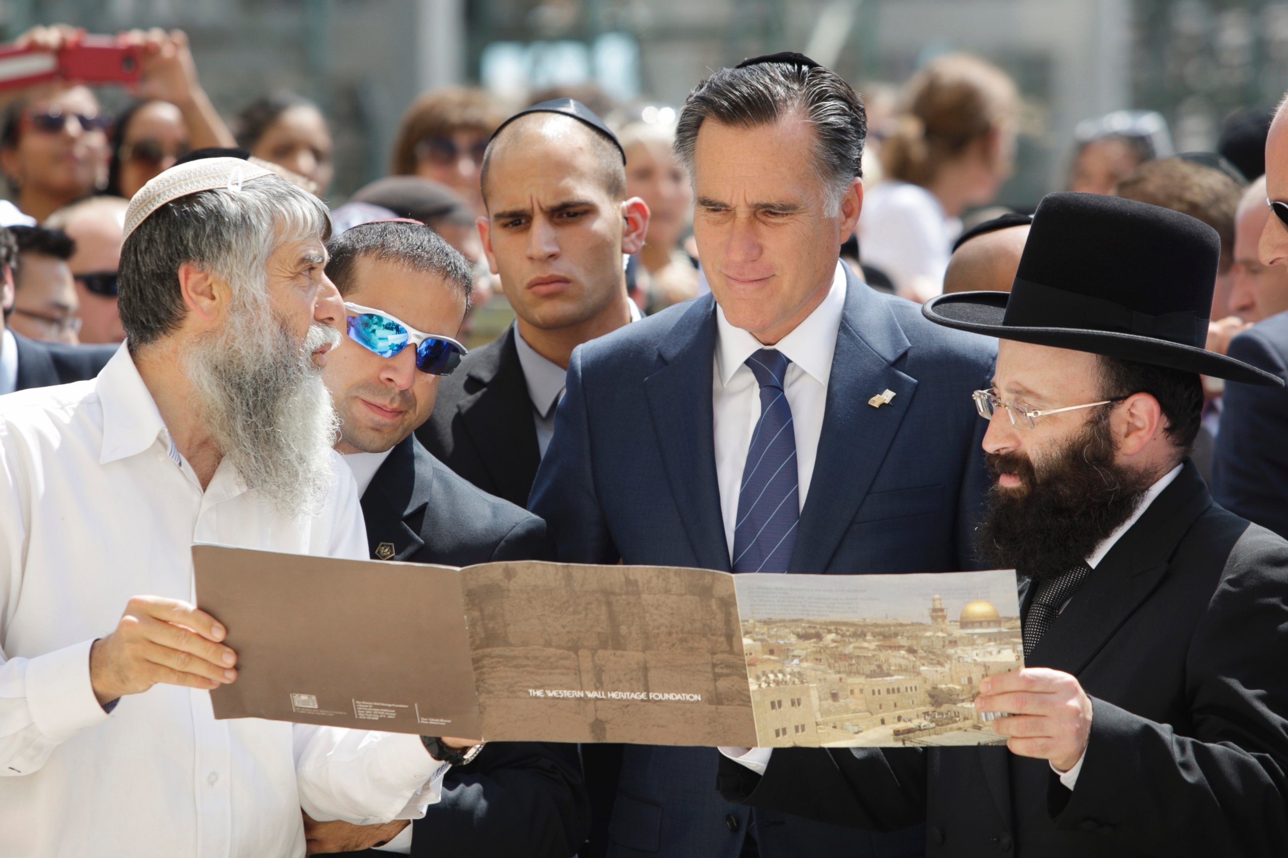 PHOTO: Republican presidential candidate and former Massachusetts Gov. Mitt Romney is presented with a booklet as he visits the Western Wall in Jerusalem, July 29, 2012. 