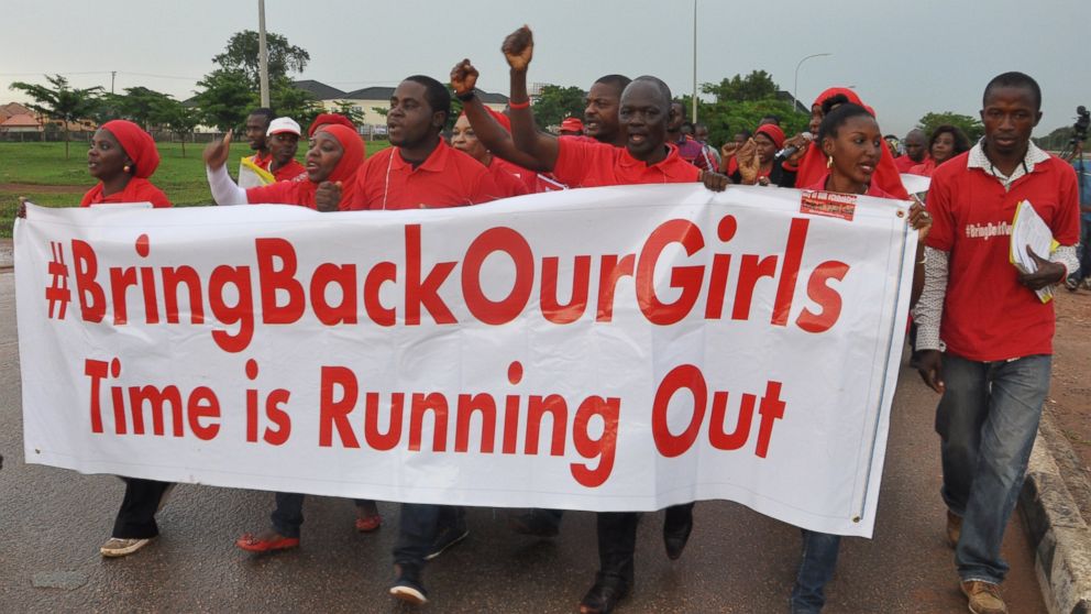 People shout slogans and hold a banner during a demonstration calling on the government to rescue the kidnapped girls of the government secondary school in Chibok, Nigeria on Sept. 11, 2014 in Abuja, Nigeria. 
