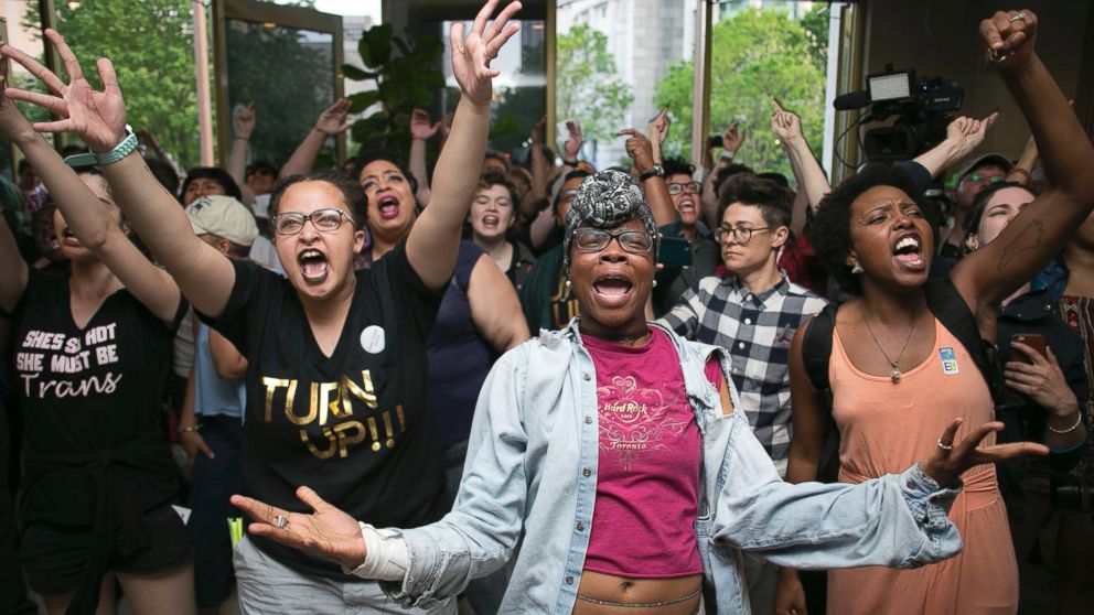 Krys Didtrey, left, and Gloria Merriweather, center, of Charlotte, N.C., lead the chants in opposition to House Bill 2 during a protest in the lobby of the State Legislative Building in Raleigh, N.C., April 25, 2016. A large group of people starting chanting in the lobby moment after the House adjourned for the evening. 
