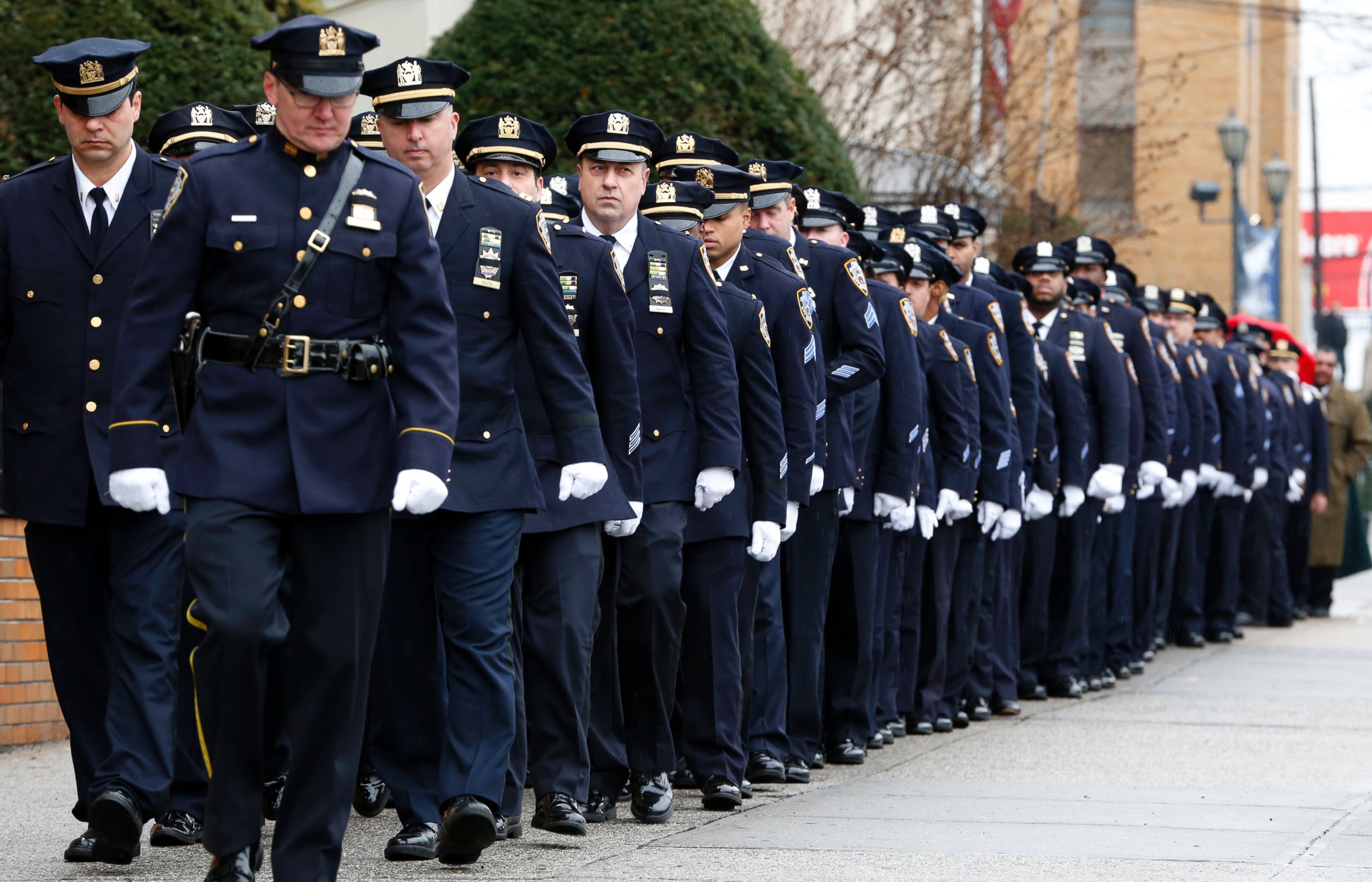 PHOTO: New York City police officers march before funeral services for police officer Wenjian Liu at Aievoli Funeral Home, Jan. 4, 2015, in the Brooklyn borough of New York.