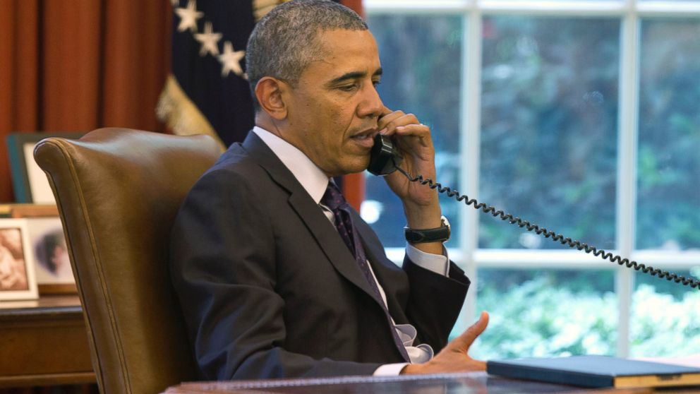President Barack Obama speaks on the phone in the Oval Office of the White House in Washington, June 2, 2014.