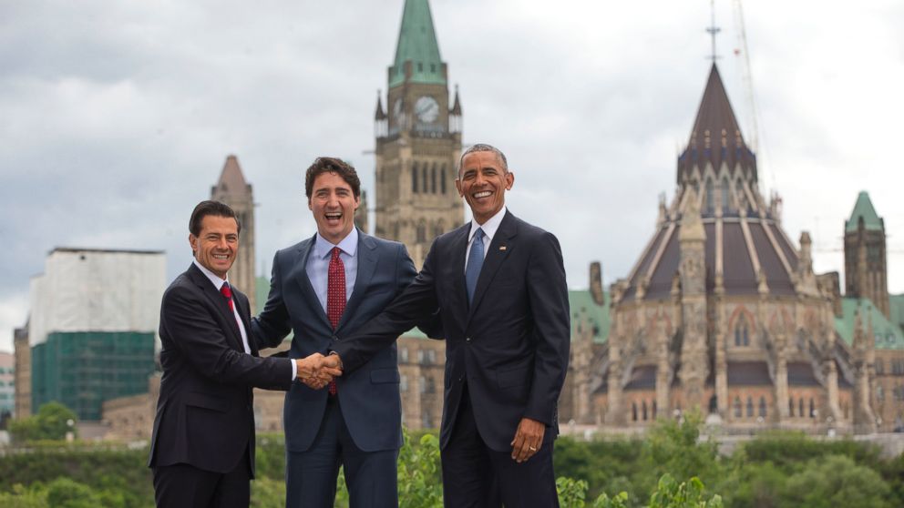 PHOTO: (L-R) Mexican President Enrique Pena Neito Mexican President Enrique Pena Neito and President Barack Obama stand in front of Parliament Hill for a group photo during the North America Leaders' Summit,  June 29, 2016, in Ottawa, Canada.