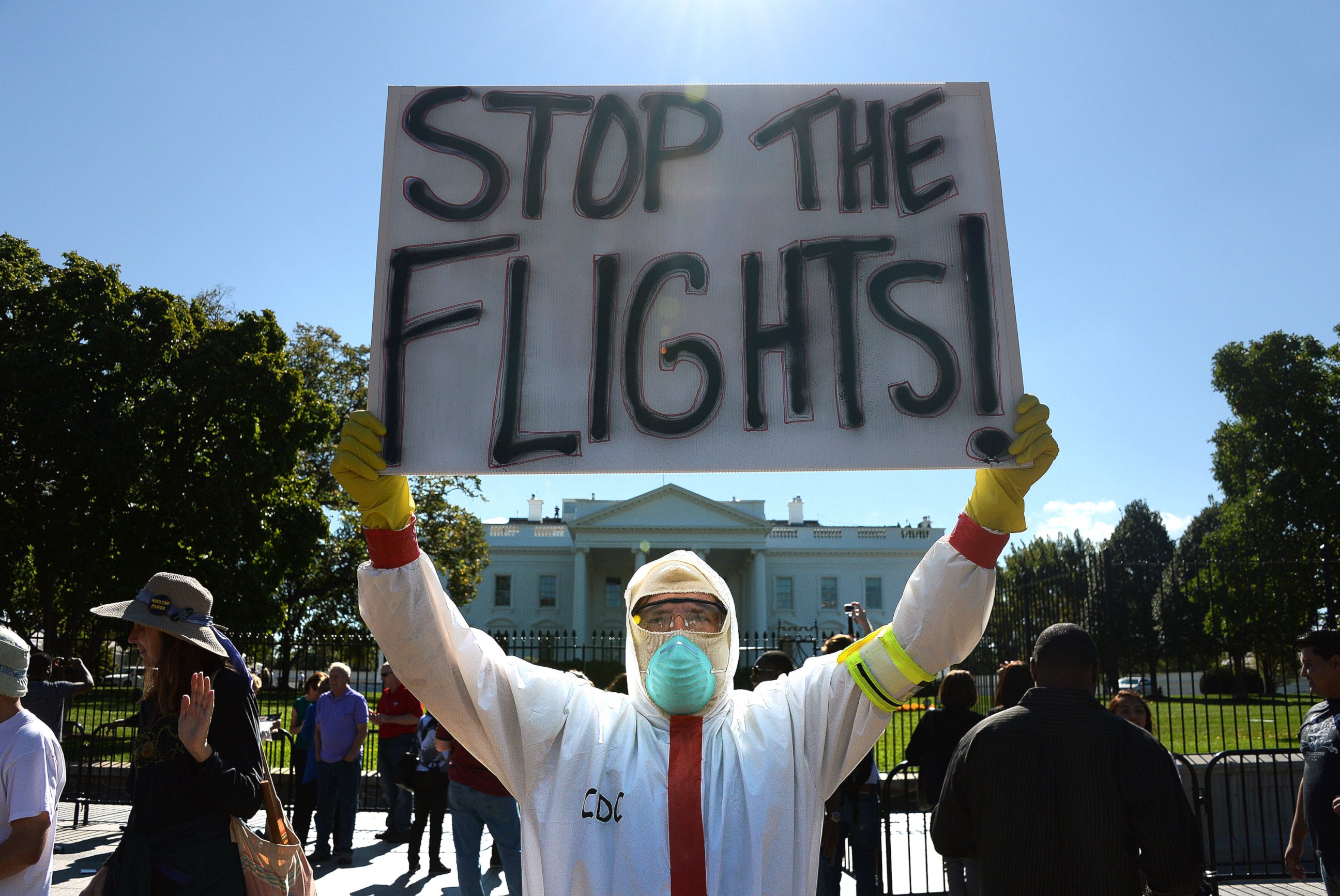 PHOTO: A protester stands outside the White House asking United States President Barack Obama to ban flights in effort to stop Ebola, Oct. 17, 2014, in Washington.