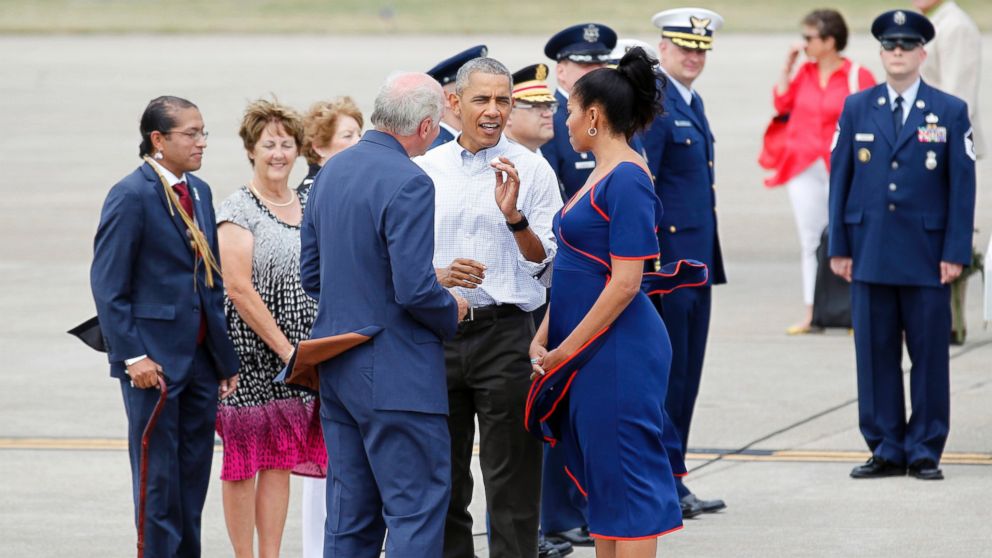 Rep. Bill Keating, D-Mass, left, gives President Barack Obama a golf ball as he greets the him and the first lady Michelle Obama, right, at the Cape Cod Coast Guard Station in Bourne, Massachusetts, Aug. 6, 2016, en route to Martha's Vineyard. 