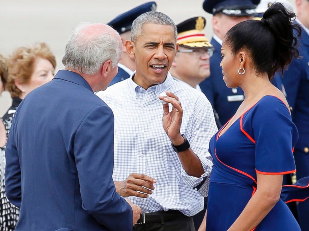 PHOTO: Rep. Bill Keating, D-Mass, left, gives President Barack Obama a golf ball as he greets the him and the first lady Michelle Obama, right, at the Cape Cod Coast Guard Station in Bourne, Massachusetts, Aug. 6, 2016, en route to Martha's Vineyard. 