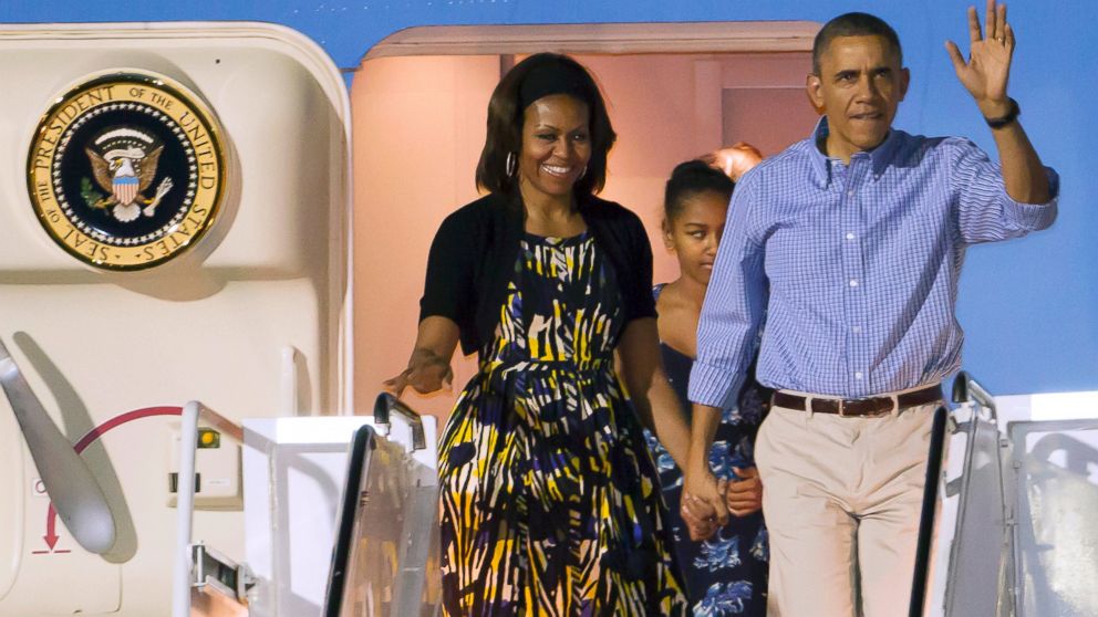 President Barack Obama, first lady Michelle Obama and Sasha disembark Air Force One after arriving at Joint Base Pearl Harbor-Hickam for their family Christmas vacation, Dec. 20, 2013, in Honolulu. 