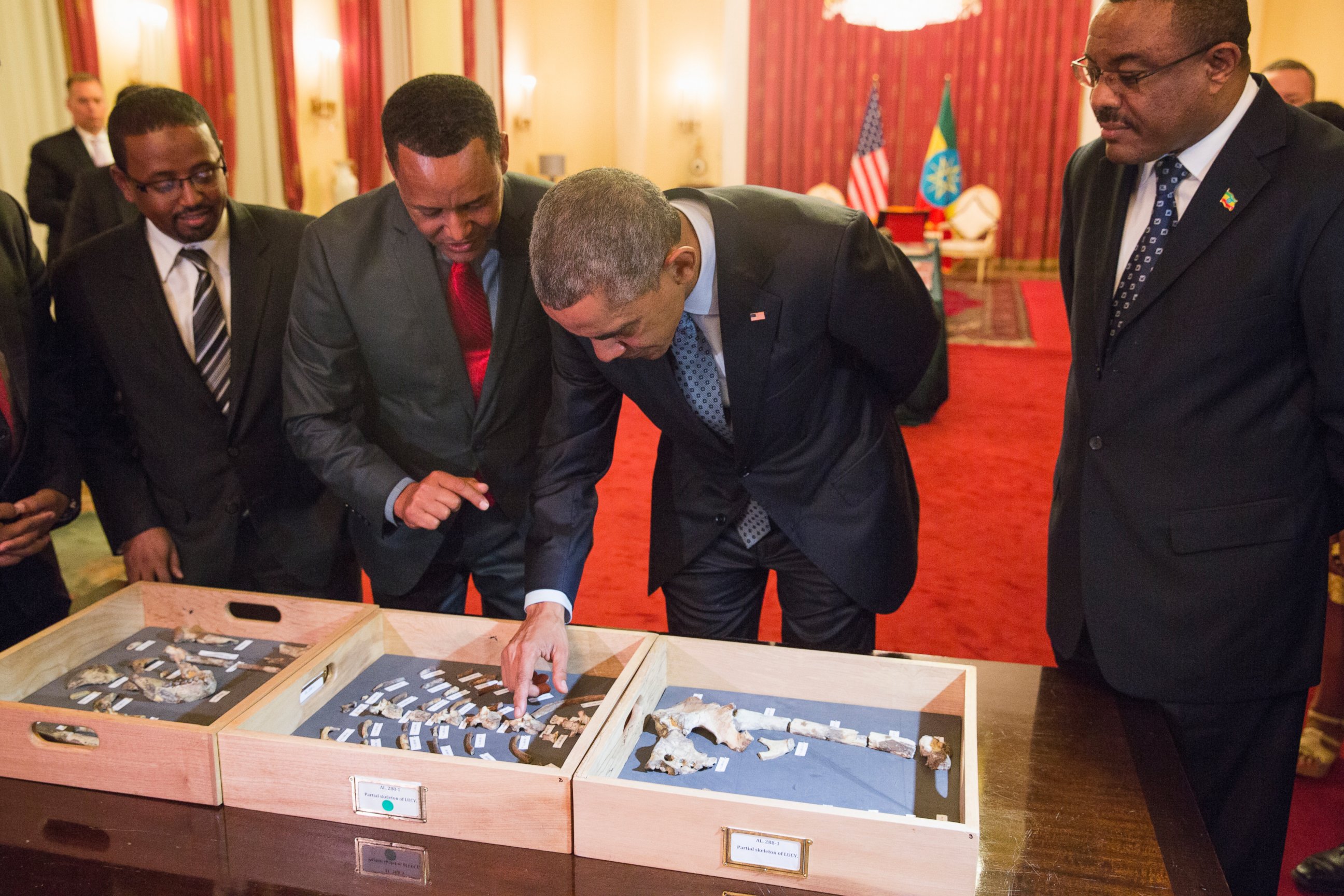 PHOTO: Ethiopian Prime Minister Hailemariam Desalegn, right, watches as President Barack Obama touches "Lucy," part of several hundred pieces of bone representing 40 percent of a female Australopithecus afarensis.