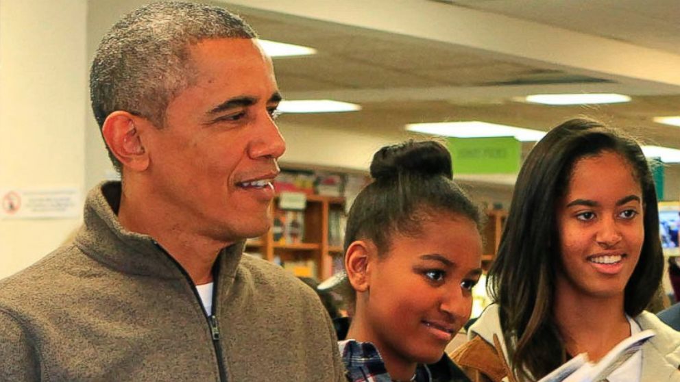 Barack Obama, left, and daughters Sasha, center, and Malia, right, purchase books at the bookstore Politics and Prose in Washington, D.C. on Nov. 29, 2014. 