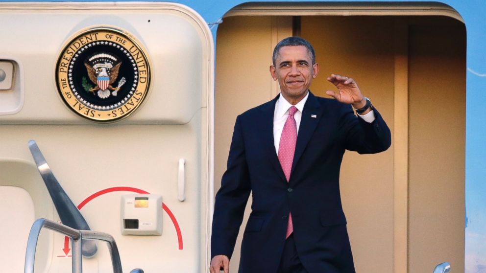 President Barack Obama waves after arriving, Nov. 24, 2013, at Seattle-Tacoma International Airport in Seattle. 