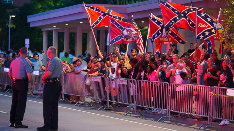 PHOTO: People wave Confederate flags outside the hotel that President Barack Obama is staying the night, July 15, 2015, in Oklahoma City.