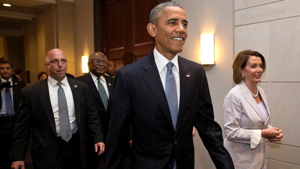President Barack Obama walks with House Minority Leader Nancy Pelosi of Calif., right and House Minority Assistant Leader James Clyburn of S.C., as he visits Capitol Hill in Washington, June 12, 2015, for a meeting with House Democrats.