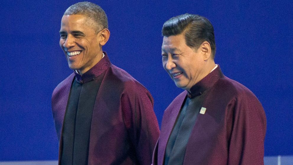 U.S. President Barack Obama, left, and Chinese President Xi Jinping walk during the Asia-Pacific Economic Cooperation (APEC) Summit family photo, Nov. 10, 2014 in Beijing.